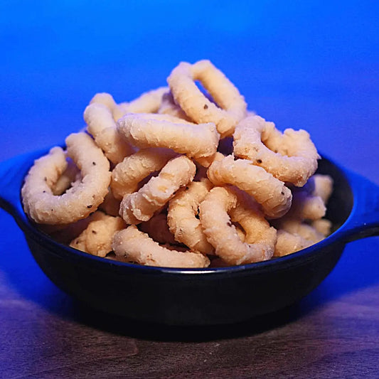 Chekodi from Estaa Sweets Bangalore – crunchy yellow ring-shaped Andhra snack made with rice flour and spices, deep-fried in pure oil with no palm oil